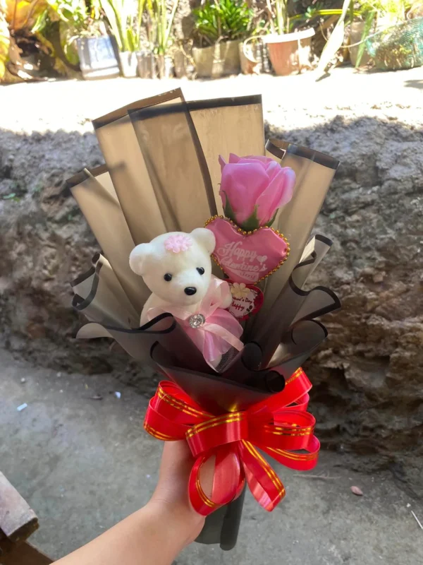 single pink rose bouquet with white teddy bear wrapped in beige wrapper