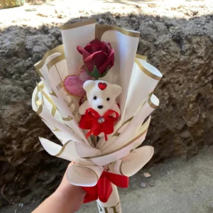 artificial, single red rose bouquet wrap in white wrapper with gold lining