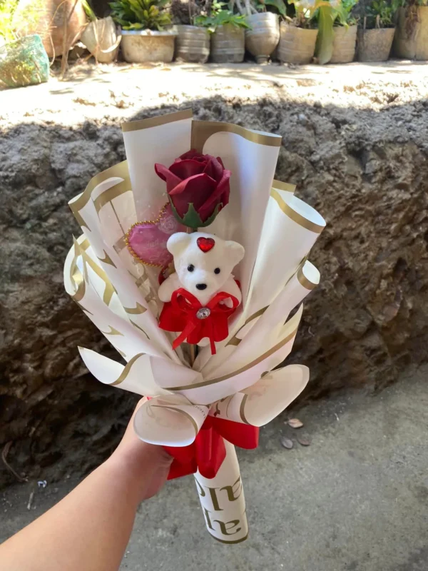 artificial, single red rose bouquet wrap in white wrapper with gold lining