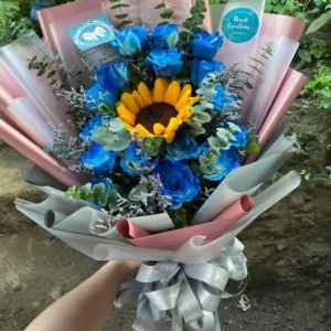 A bouquet of Blue Roses with a Sunflower in the middle.