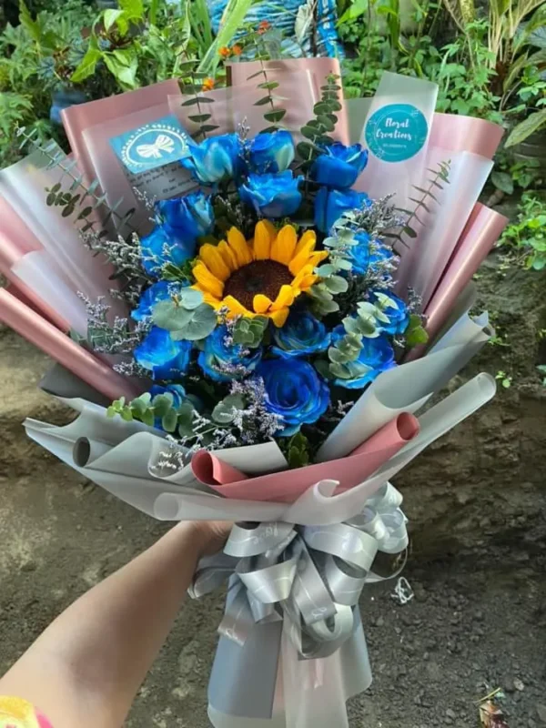 A bouquet of Blue Roses with a Sunflower in the middle.