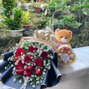 A bouquet of Red Roses, Ferrero Rocher and a Teddy Bear.