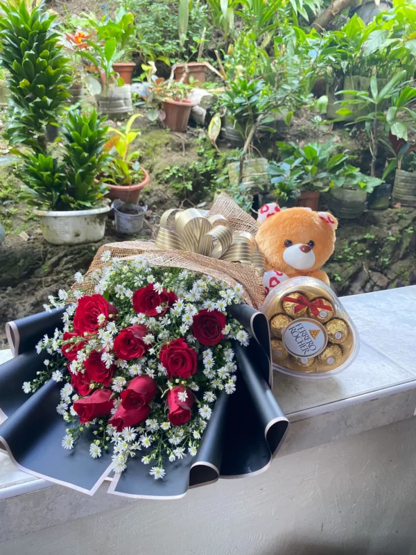 A bouquet of Red Roses, Ferrero Rocher and a Teddy Bear.